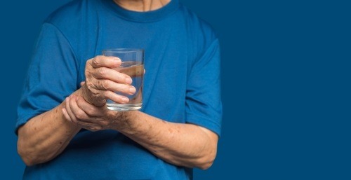 Close-up,Of,Hands,Senior,Woman,Trying,To,Hold,A,Glass